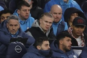 Erling Haaland (centre) watched Manchester City's defeat to Liverpool from the substitute's bench