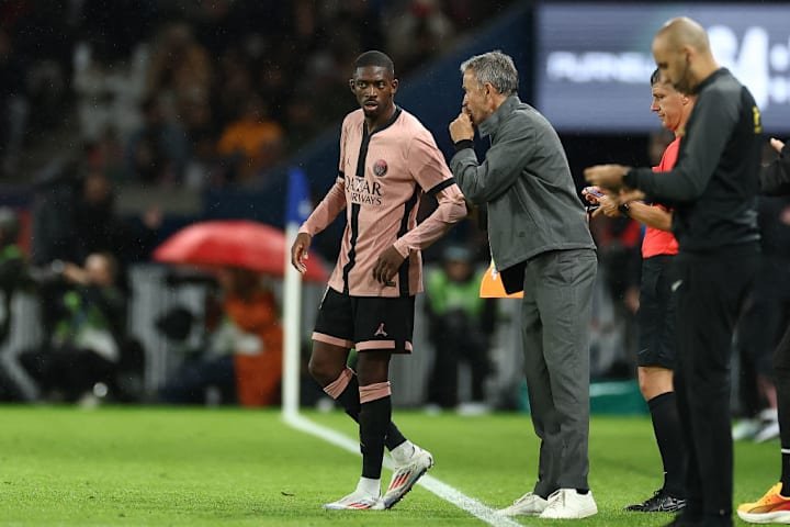 Luis Enrique and Ousmane Dembele engage in conversation on the touchline during PSG's Ligue 1clash with Rennes